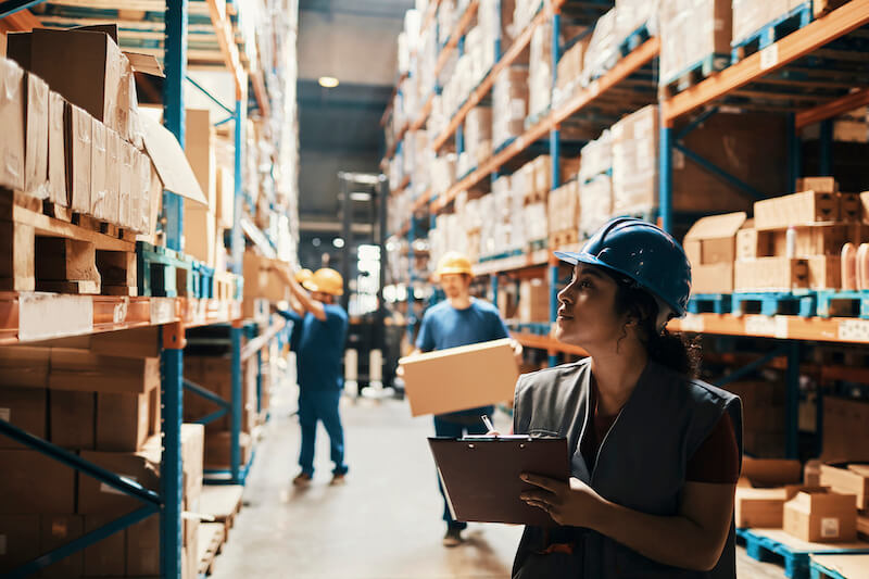Workers handling packages in a warehouse